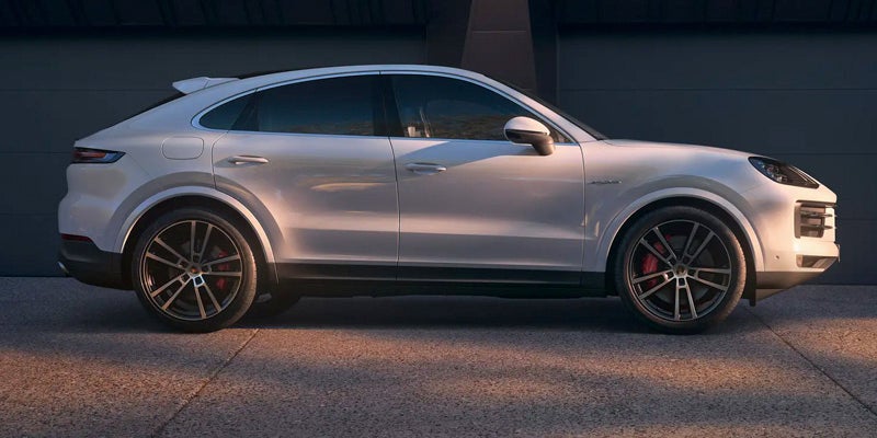 The sun setting on a white 2024 Porsche Cayenne Coupe