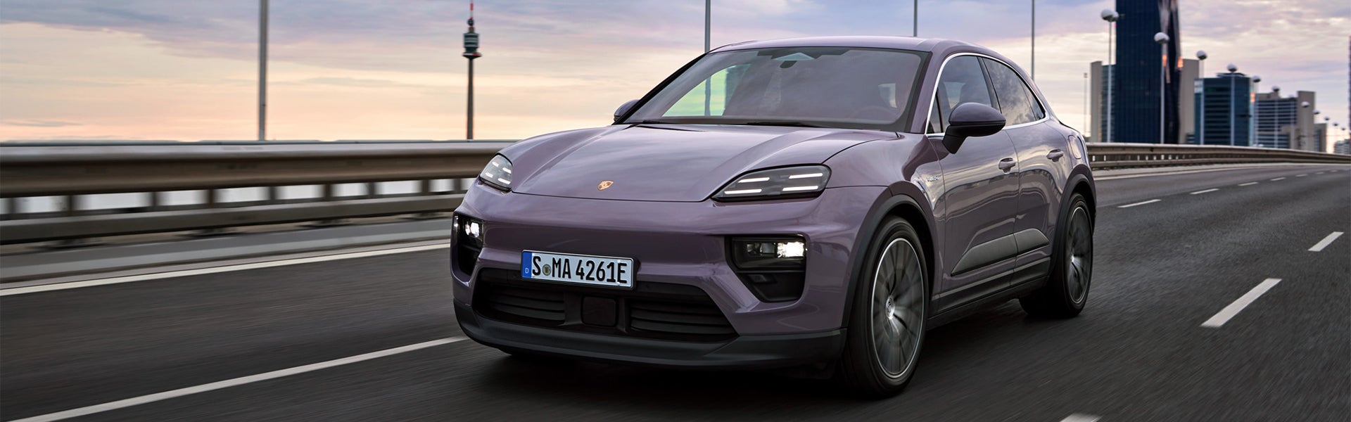 A dreams provence 2024 Porsche All- Electric Macan 4 driving down the highway at dusk